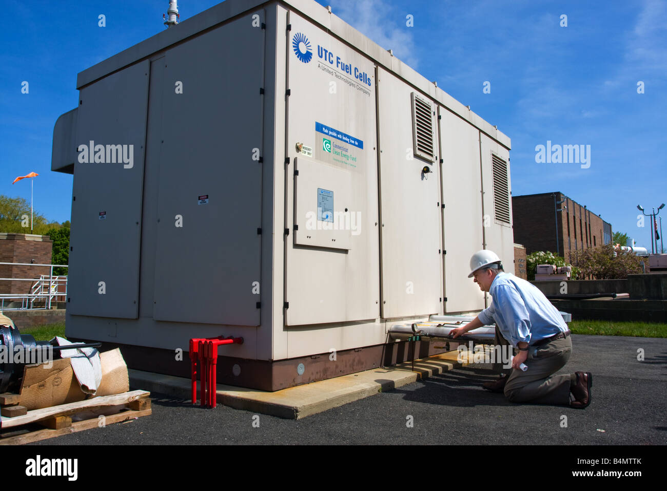 An engineer looks over a fuel cell power generator in Connecticut USA