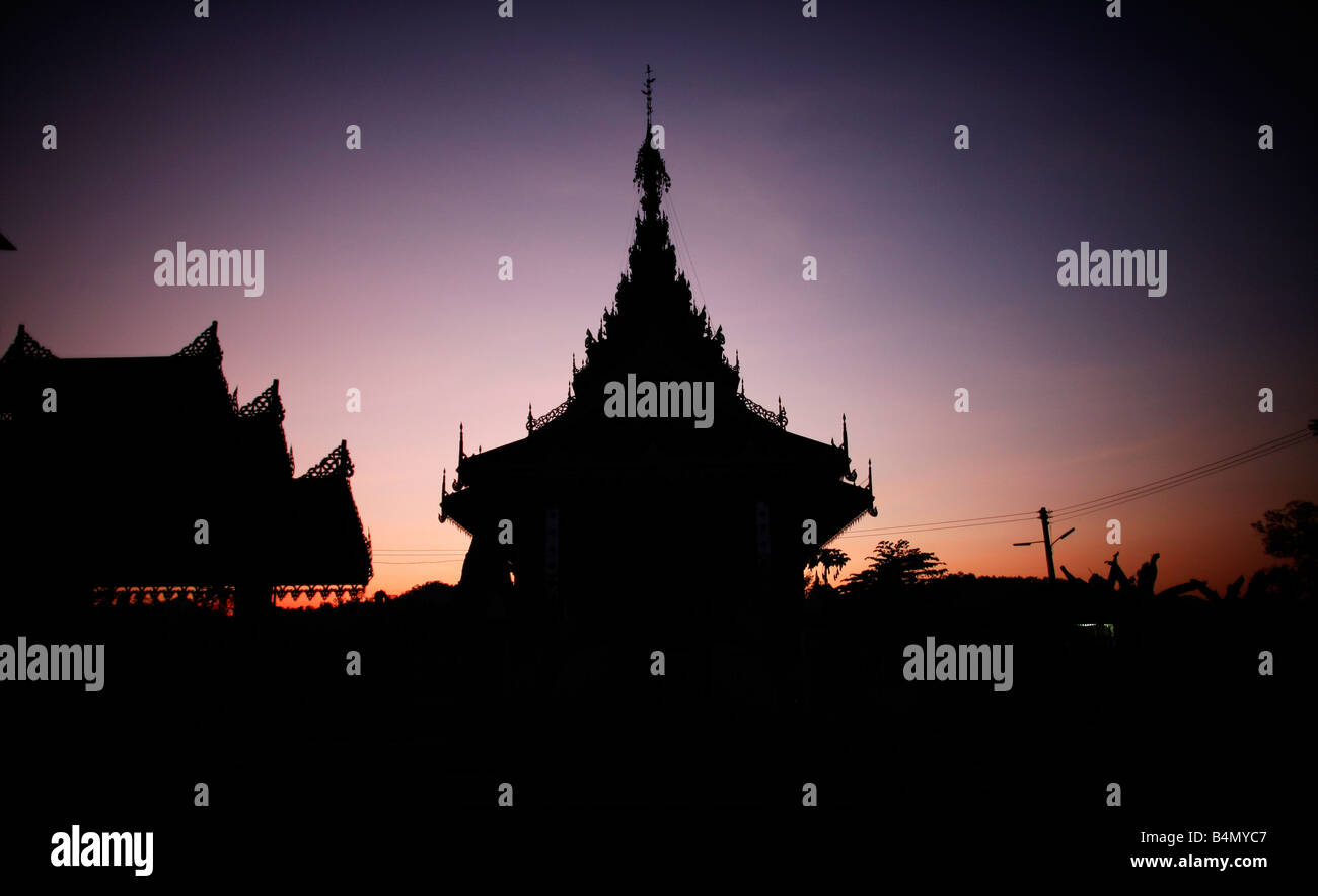 Silhouette of a temple in Mai Soi Nearby live approximately 300 Burmese refugees who are members of the indigenous group known as the Longnecks The largest of the three villages where the Longnecks live is called Nai Soi located near Mae Hong Son City Longnecks wear metal rings on their necks which push the collarbone down and extend the neck They are a tourist attraction Tourists visit Nai Soi to take pictures of the Longnecks and buy their handicrafts The villages are criticized by human rights organizations as human zoos Stock Photo