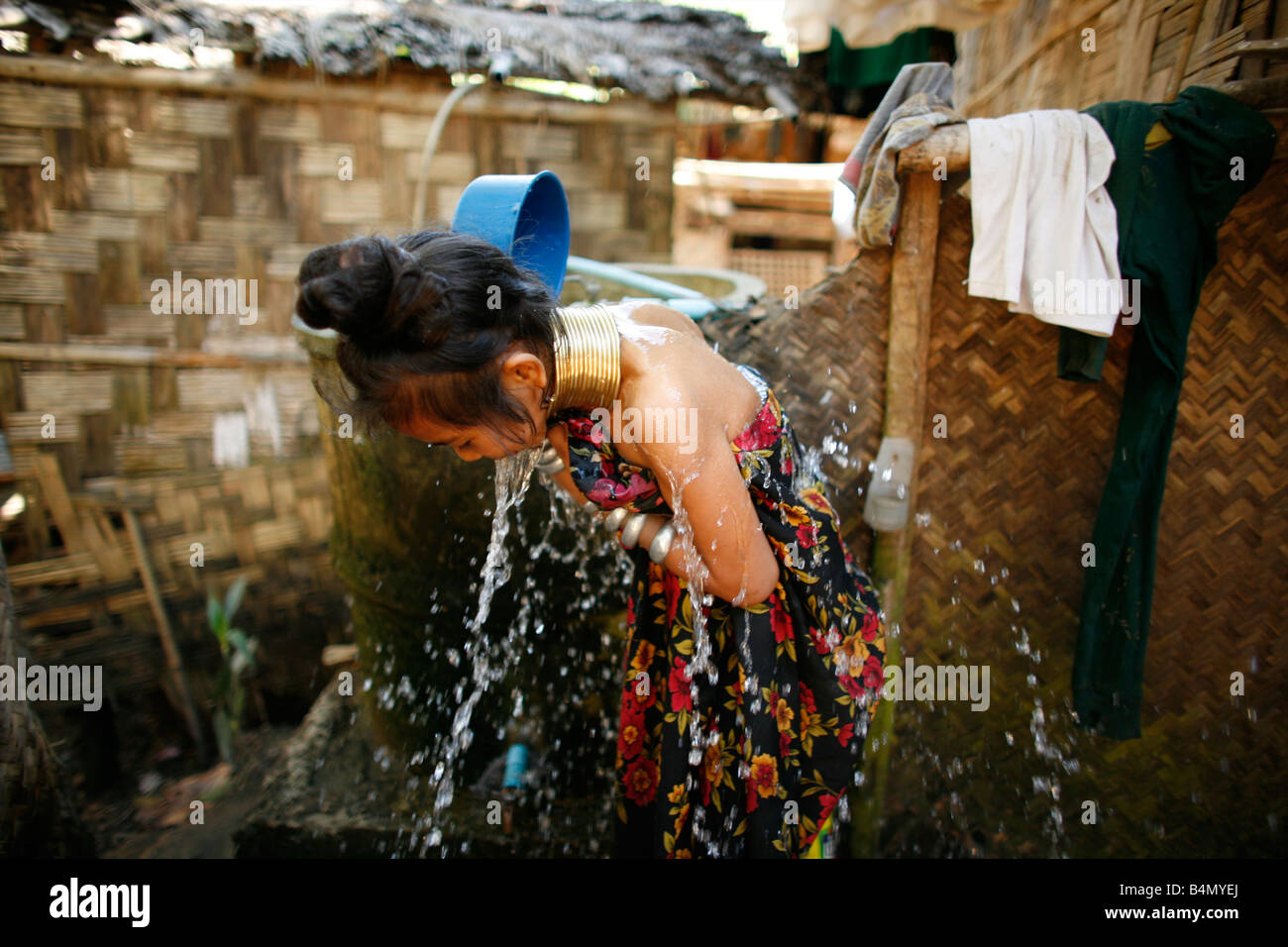 A Longneck girl splashes herself with water Approximately 300 Burmese ...