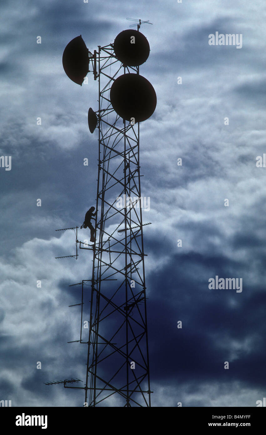 man climbing communications tower Stock Photo Alamy