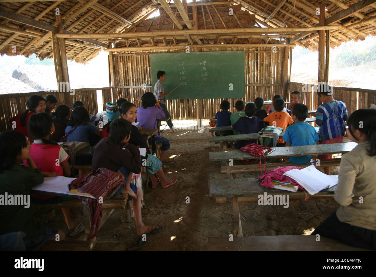 A teacher instructs pupils at a primary school in Mae Sot refugee camp Around 130 000 Burmese refugees have settled in Thailand due to opression in their homeland of Myanmar Burma Approximately 30 000 refugees now live in Mae Sot western Thailand and receive humanitarian aid Another 200 Burmese refugees have settled in La Per Her a village on the Burmese side of the border with Thailand The refuse to cross because they want to remain in their homeland These refugees support the rebel movement KNLA Karen National Liberation Army which operates in eastern Burma Jan 2007 Stock Photo