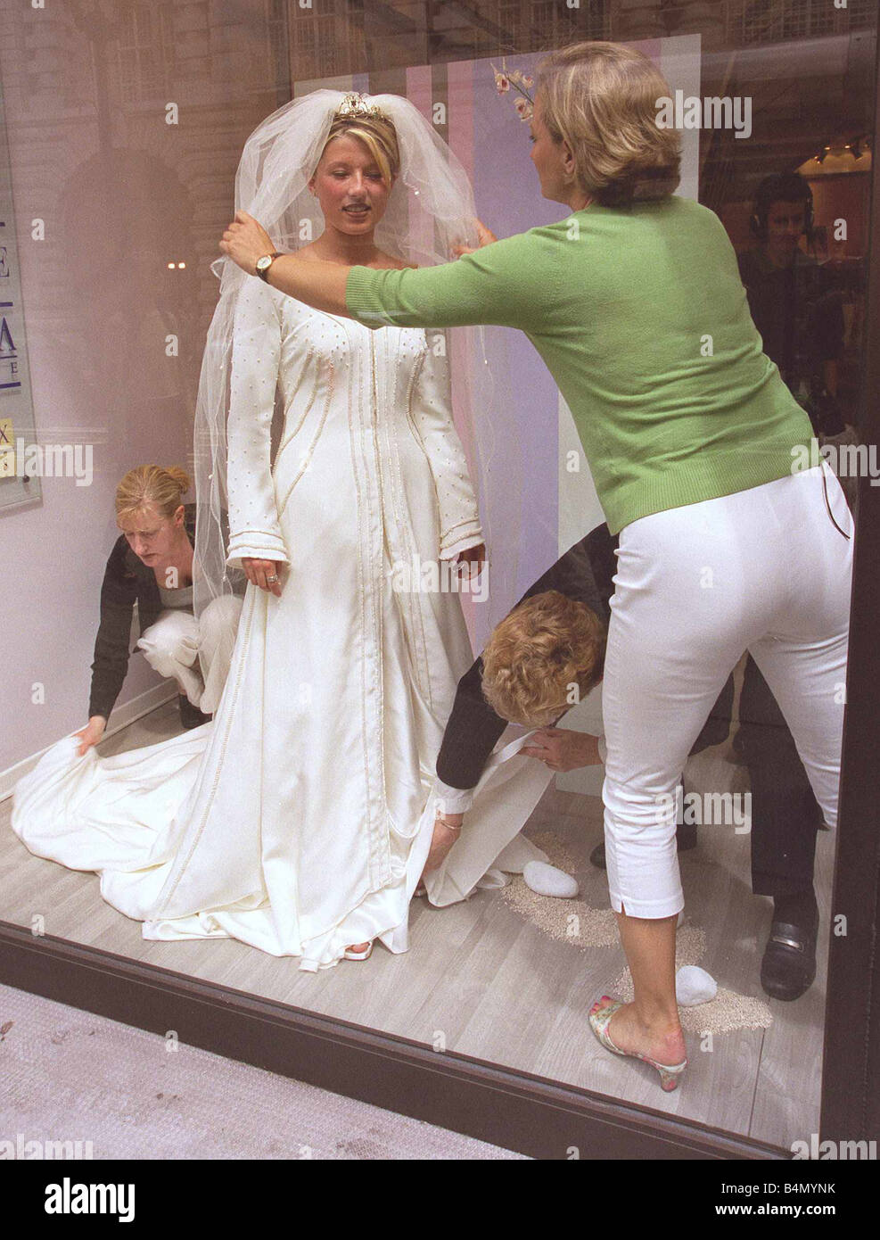 Berkertex Brides Shop June 1999 Maranne Crick Fashion Student standing in shop window wearing Replica of Royal Wedding Dress put together by Helen Marina Designer at Berkertex Brides Shop challenge commissioned by BBC Watchdog Programme being helped with final preparations by Alice Beer TV Presenter Stock Photo