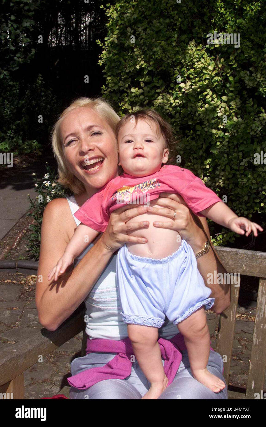 Tania Bryer TV Presenter July 1999 holding baby daughter Natasha Joy Moufarrige at home in London Stock Photo