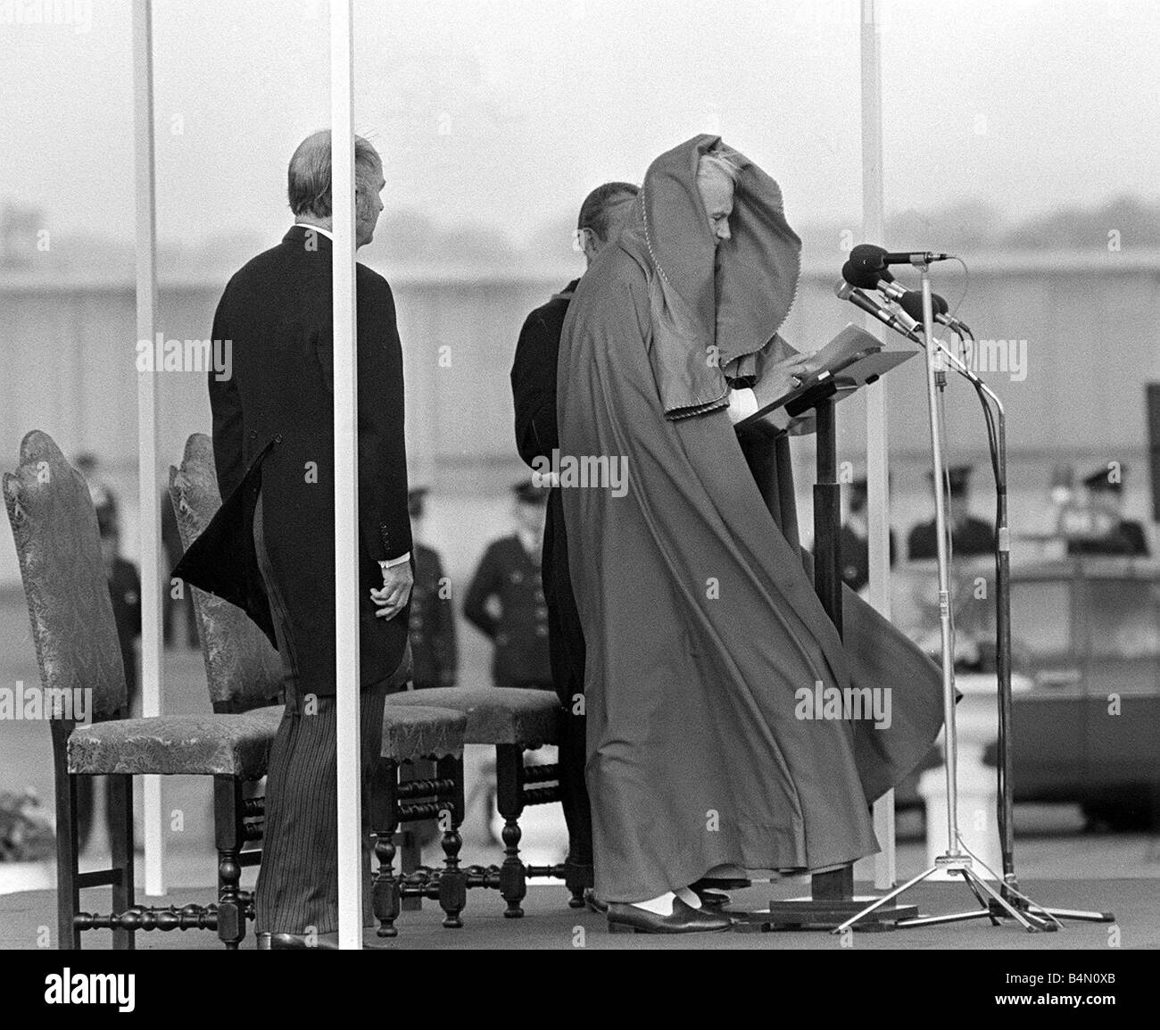 Pope John Paul II during his visit to Ireland 1979 The Pope s robe is blown over his head as he addresses his audience on his arrival in Ireland Stock Photo