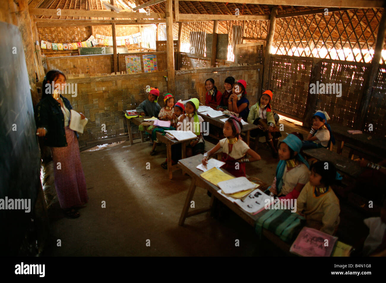 A Longneck teacher addresses her class Approximately 300 Burmese refugees in Thailand are members of the indigenous group known as the Longnecks The largest of the three villages where the Longnecks live is called Nai Soi located near Mae Hong Son City Longnecks wear metal rings on their necks which push the collarbone down and extend the neck They are a tourist attraction Tourists visit Nai Soi to take pictures of the Longnecks and buy their handicrafts The villages are criticized by human rights organizations as human zoos Stock Photo