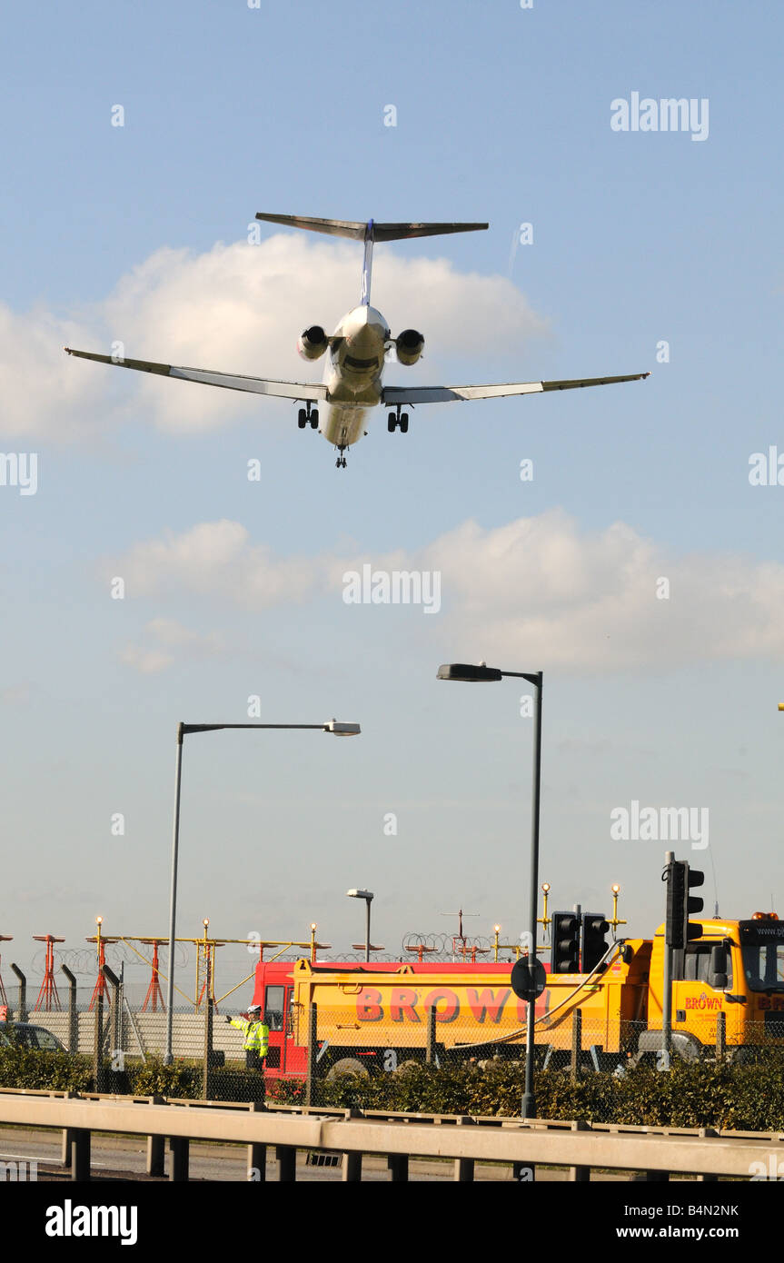 Airplane coming in to land cross the A4 at heathrow Airport London Britain Uk england Stock Photo