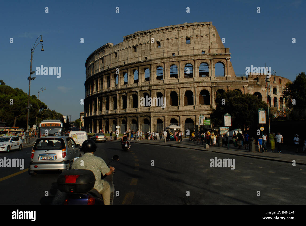 Traffic passing the Colosseum in Rome, Italy Stock Photo