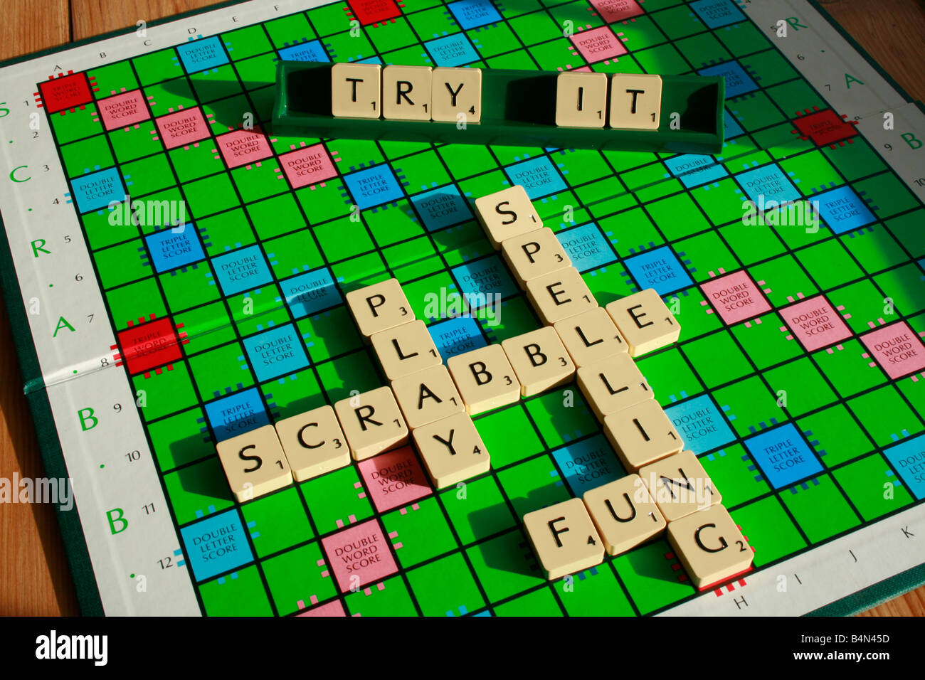 Scrabble board with letter tiles inviting you to play and improve