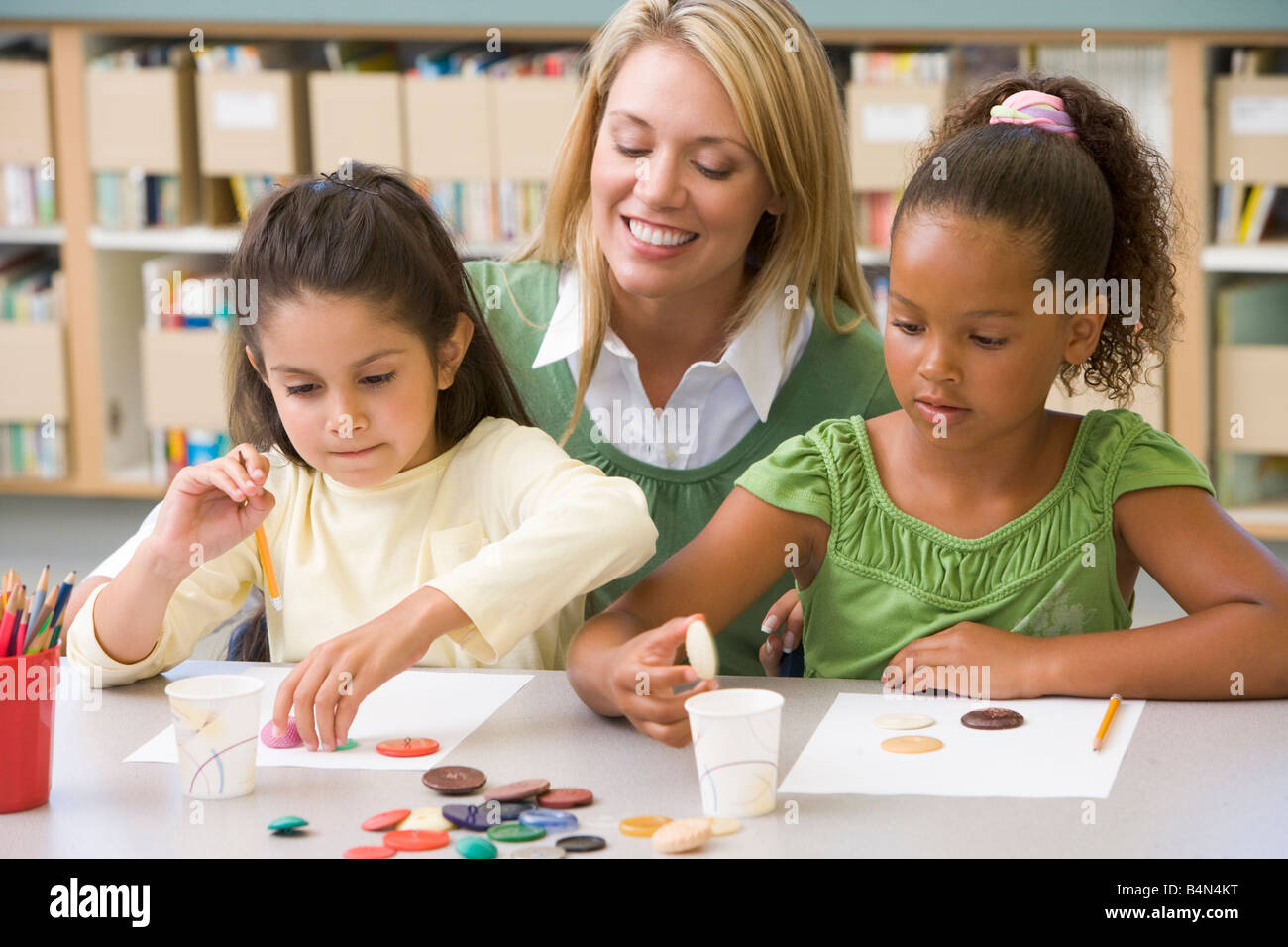 Two students in art class with teacher stock photo alamy