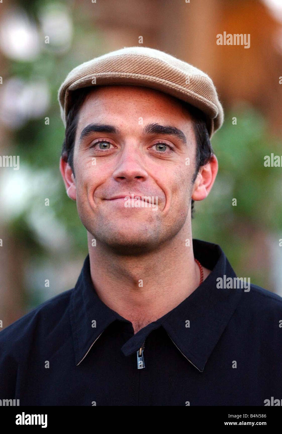Robbie Williams April 2002 pictured at the Coachella Music festival in Palm Springs California Robbie Williams made a surprise appearance not performing cap hat Stock Photo