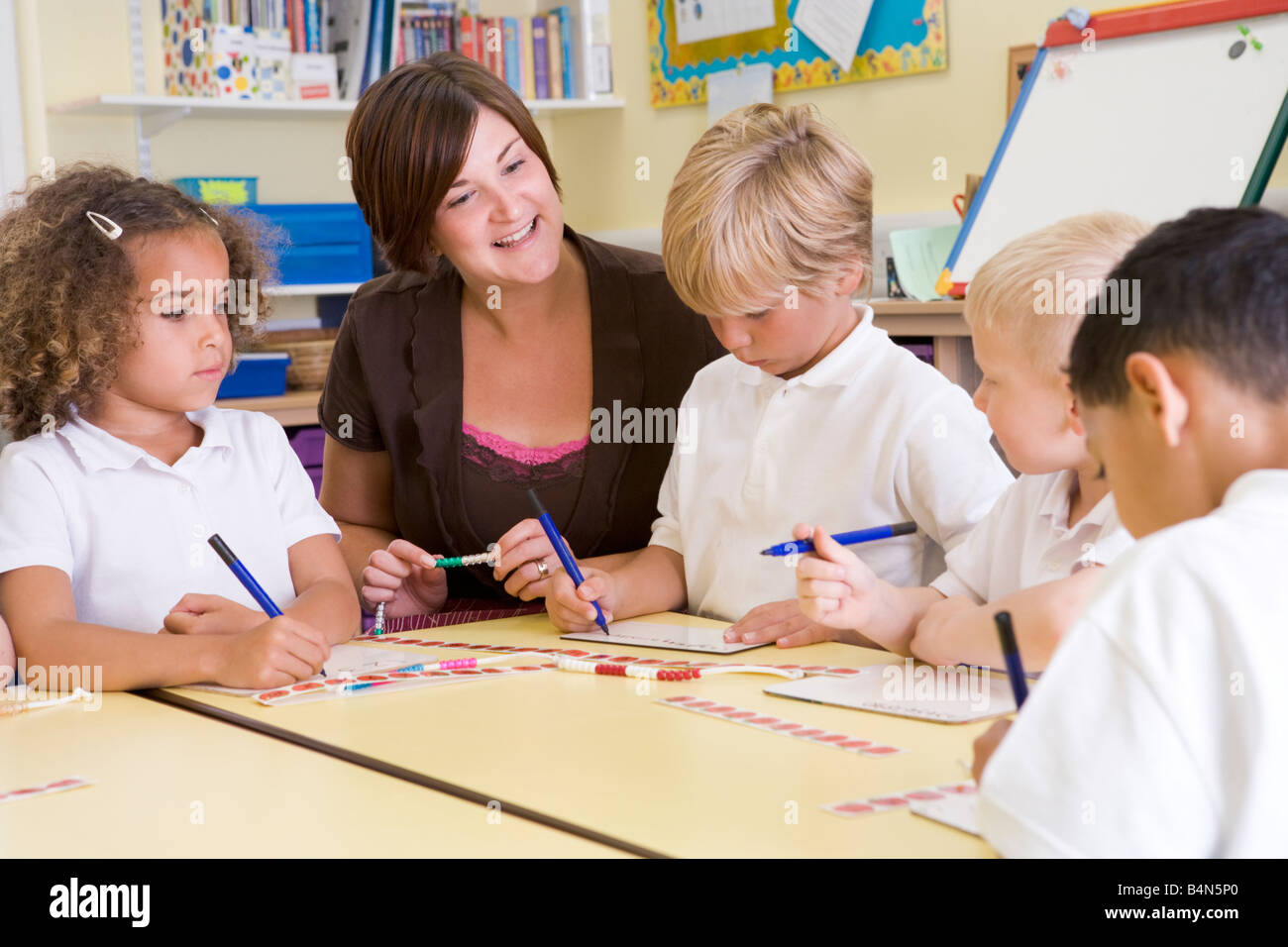 Students and teacher in math class with counting beads Stock Photo