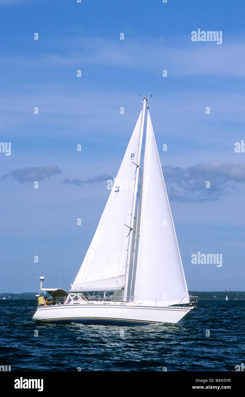 White sailboat sailing off Cape Cod under full sail main and jib Stock Photo Alamy