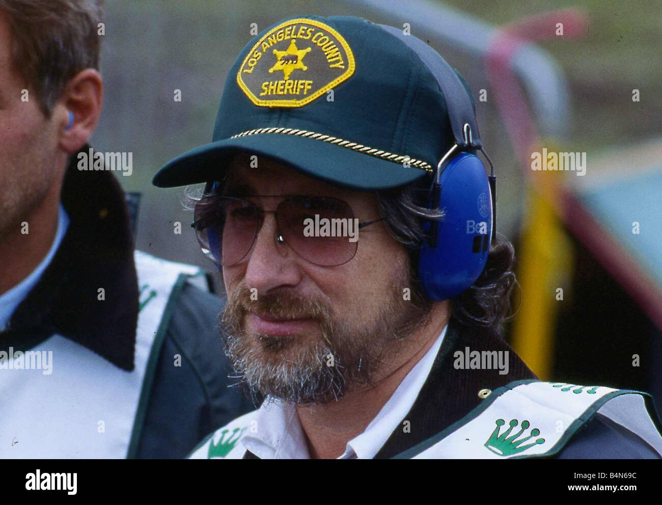 Steven Spielberg Cancer Research shoot Gleneagles 1988 baseball cap ear  protectors glasses Stock Photo - Alamy
