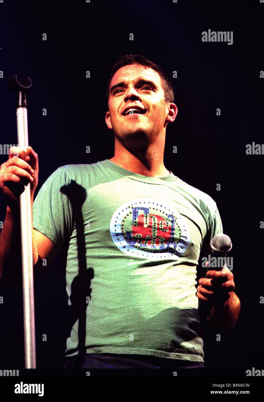 Robbie Williams in concert at Slane Castle Ireland August 1999 Controversial pop star Robbie Williams enjoyed the proudest moment of his glittering career at Slane Castle Thousands of Ulster fans joined the 80 000 sell out crowd converged on the prestigious venue for the gig of the century Stock Photo