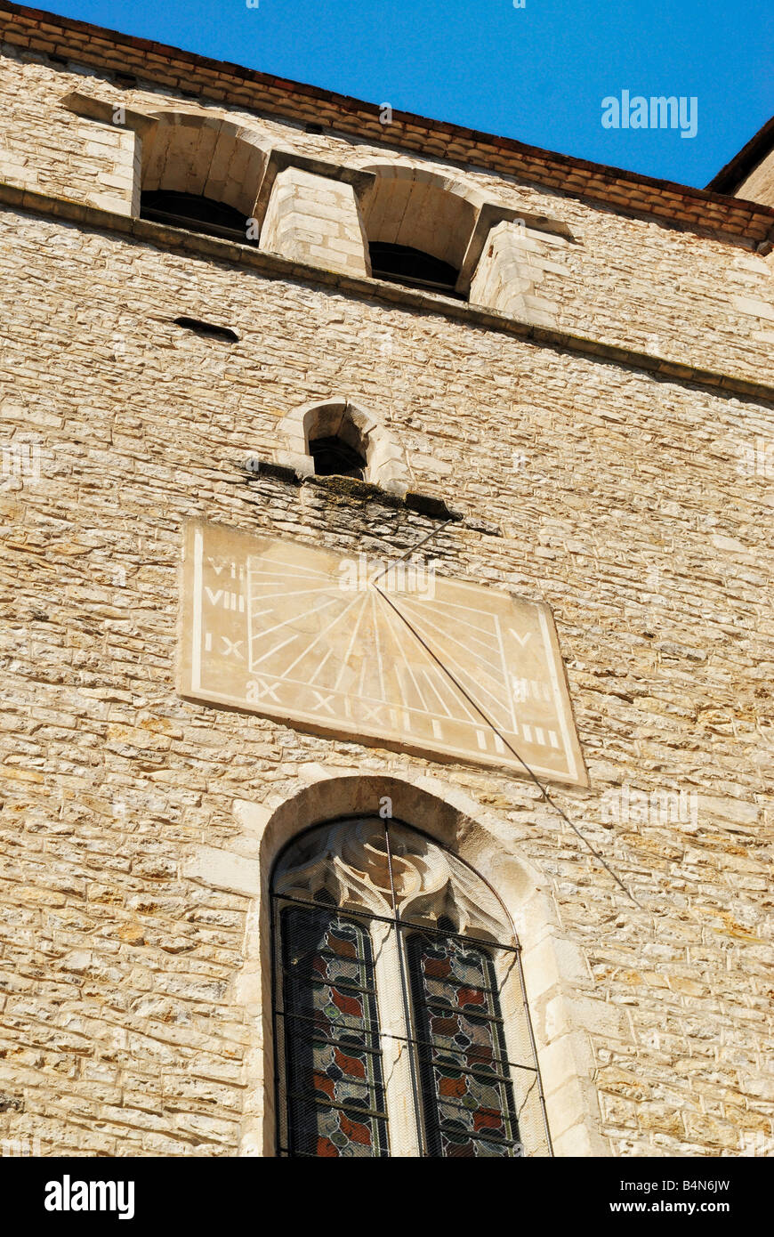 Low angle view of Church with sundial at Saint Cirq Lapopie, Midi Pyrénées, Lot, France Stock Photo