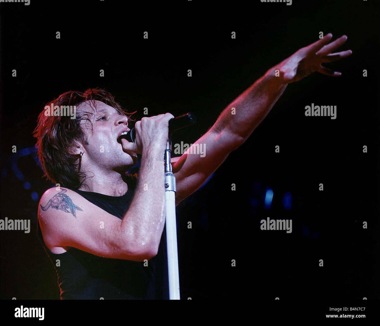 Jon Bon Jovi lead singer of rock group Bon Jovi raises his hand to the ...