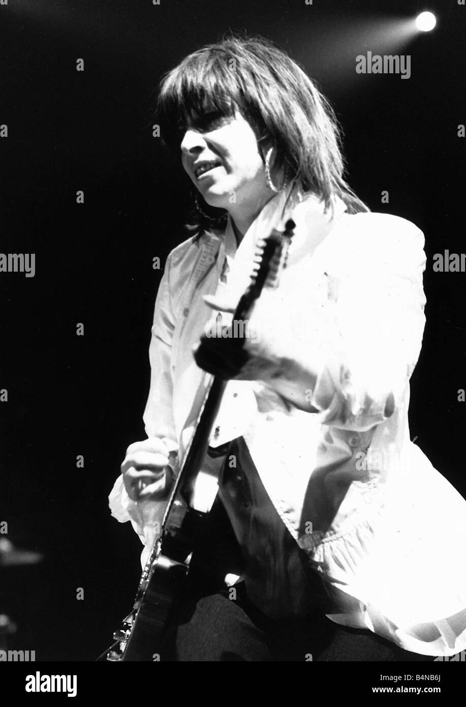 Chrissie Hynde singer with The Pretenders pop group 1987 playing guitar in concert at Wembley Arena Stock Photo