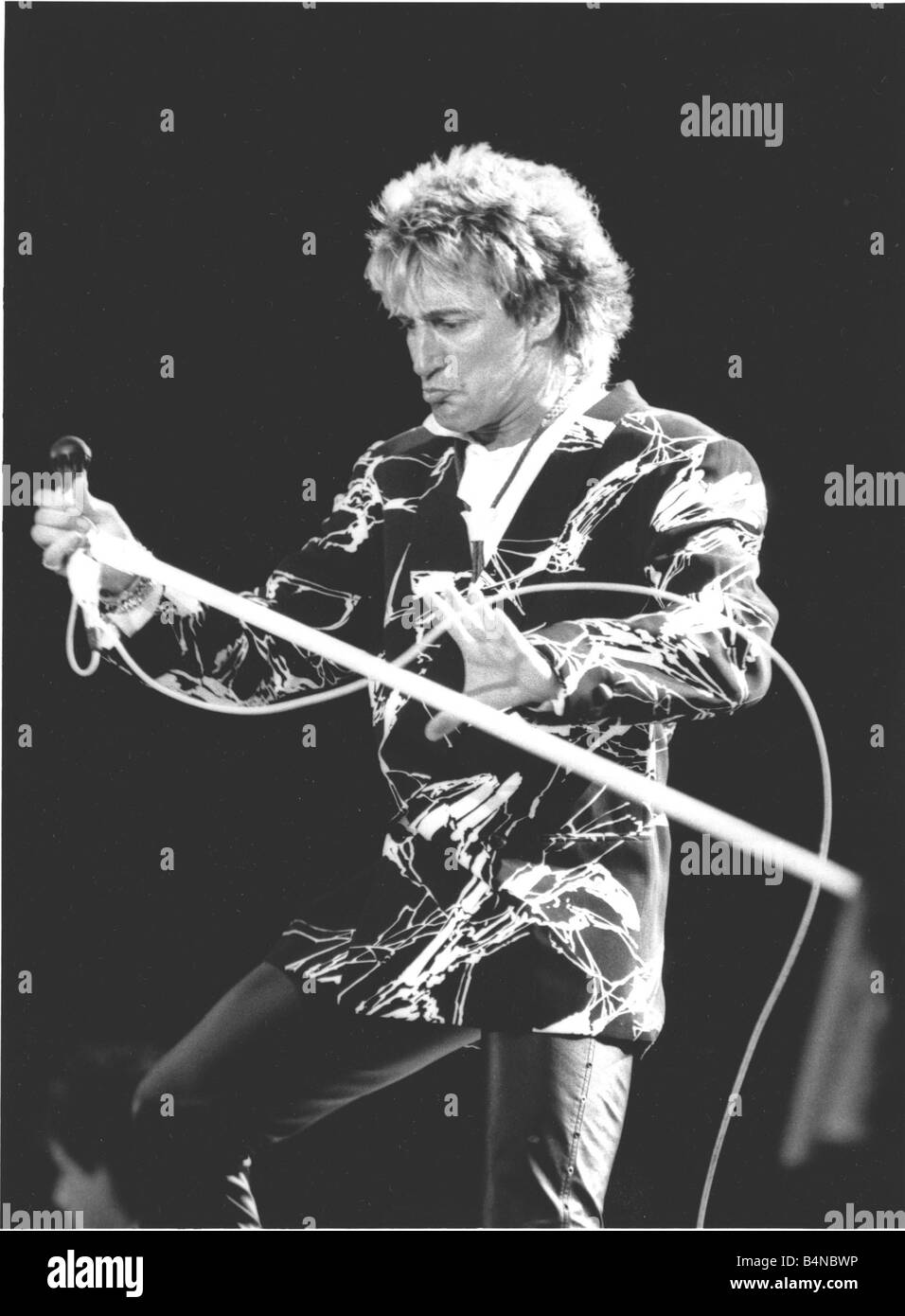 Veteran Rocker Rod Stewart went down a storn at Wembley Stadium on 15 July 1986 and so did the rain Rod sang to a sea of umbrellas during an emotional reunion with his old backing band The Faces The band watched by 60 000 fans played together for the first time in 13 years The concert was staged to raise money for a new clinic for victims of multiple sclerosis the disease that struck down former Faces guitarist Ronnie Lane Stock Photo