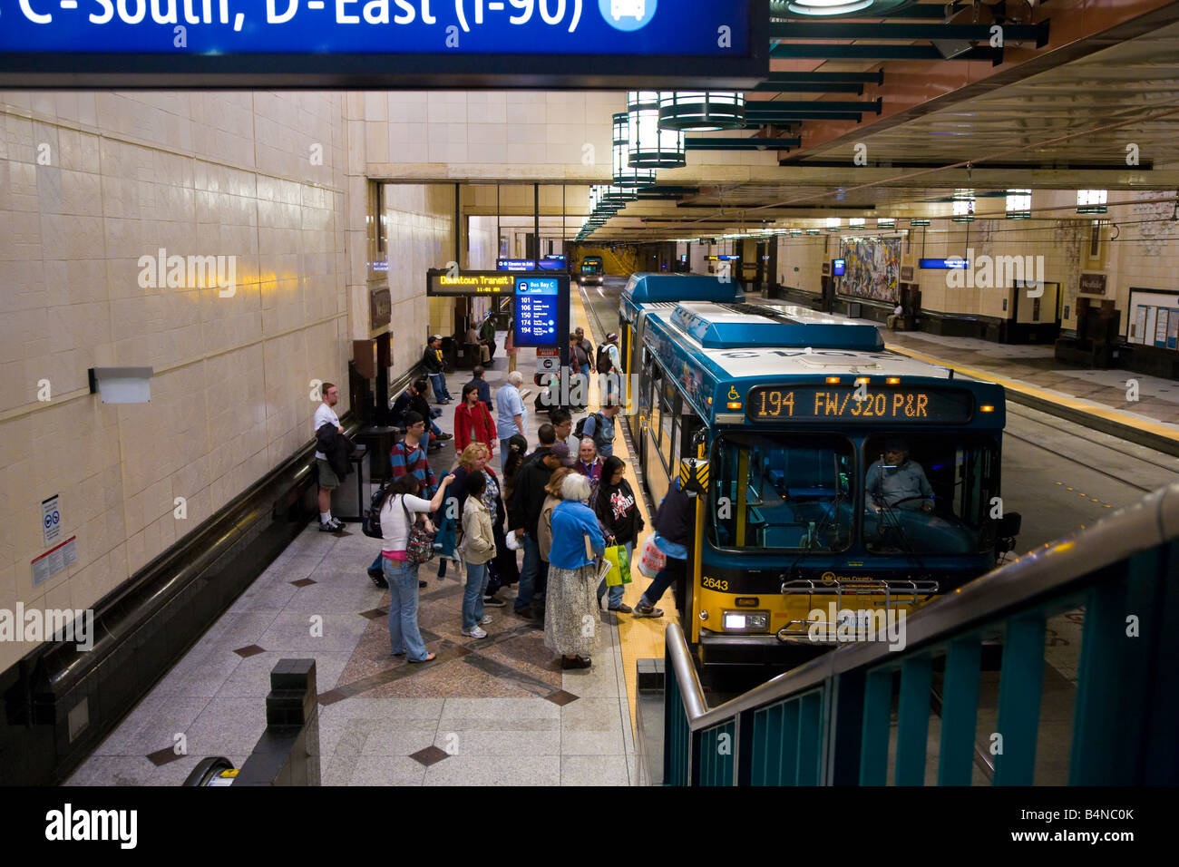 People boarding city bus in underground terminal on south side of Seattle Washington Stock Photo