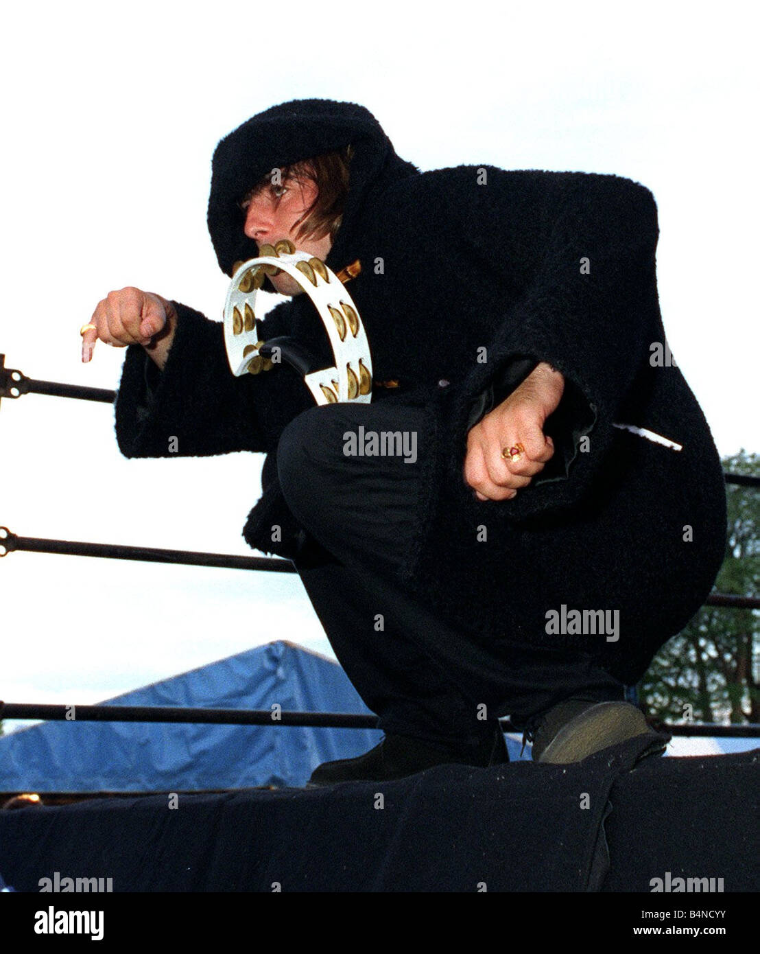 Liam Gallagher playing the tambourine during the Oasis concert at Balloch Country Park Loch Lomond August 1996 Stock Photo
