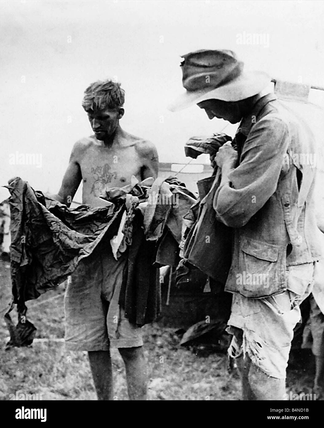 Prisoners of War commonwealth POW japanise camp soldiers army military sorting clothes rags Stock Photo
