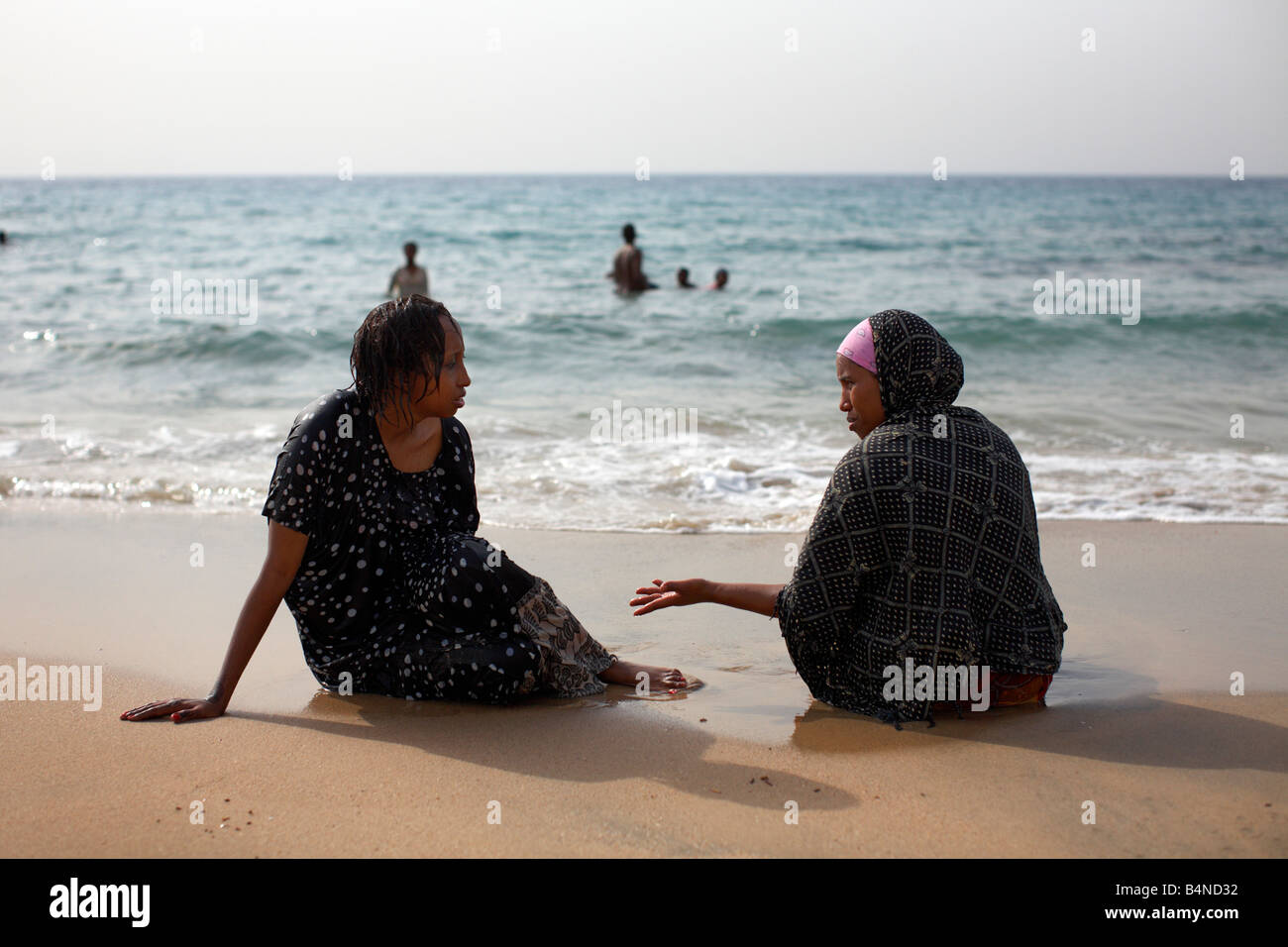 Muslim women chat on a beach in Berbera, Somaliland, Somalia Stock Photo