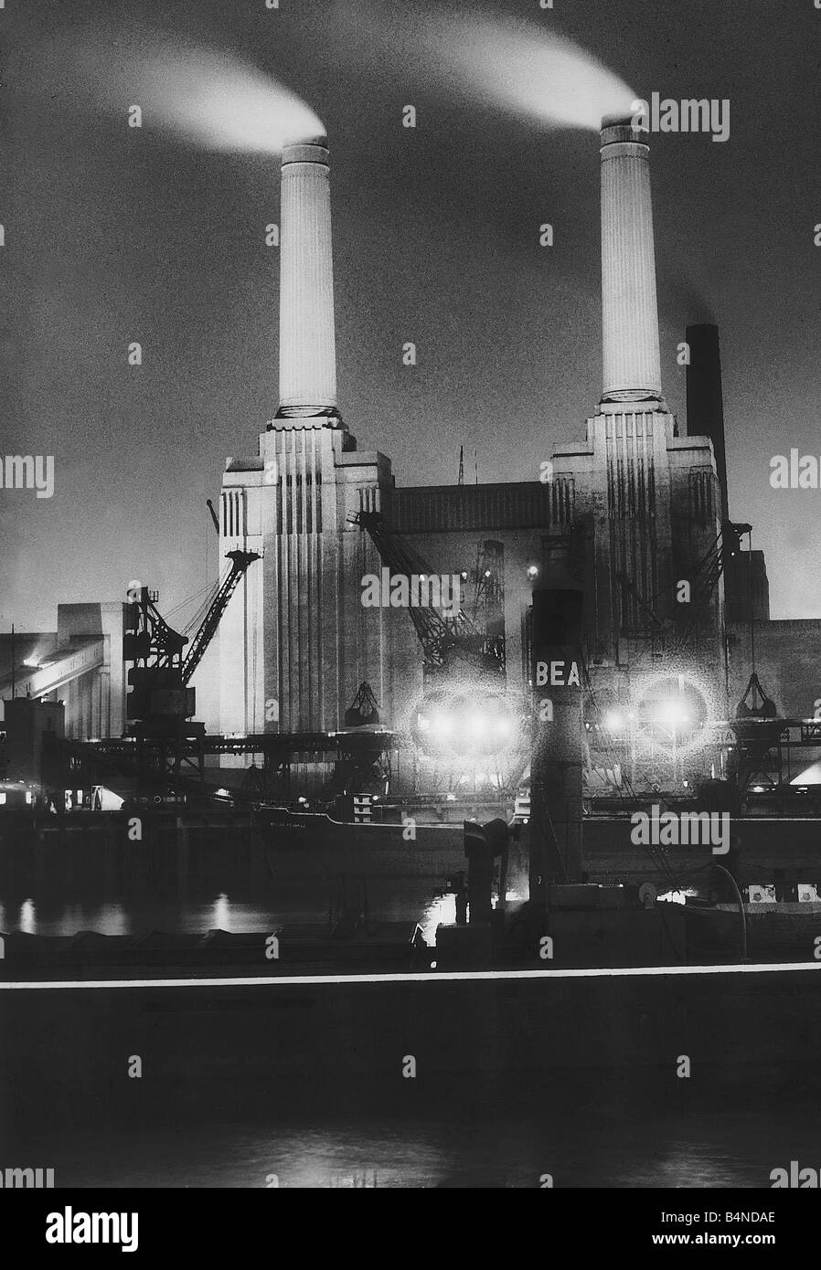 Battersea Power Station at night July 1950 Coal ships unload at Battersea Power Station Stock Photo