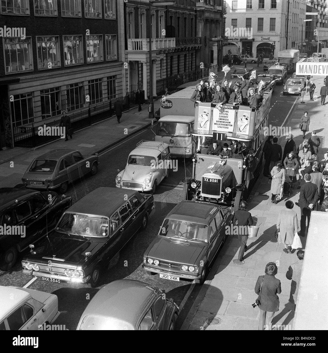 Open top 1925 Double Decker bus Feb 1972 going through the streets of