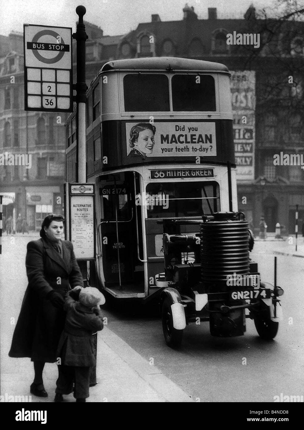 A double decker bus with a fuel trailer attached March 1943 London Transport try this new type of fuel in place of petrol Stock Photo