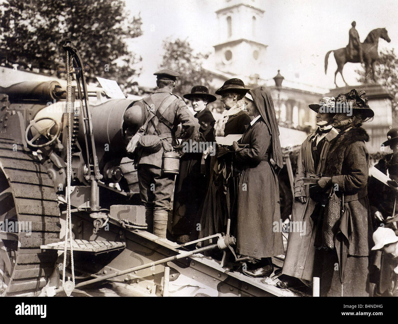 Women queue fo buy war bonds at Trafalgar Square A Soldier stands by a ...