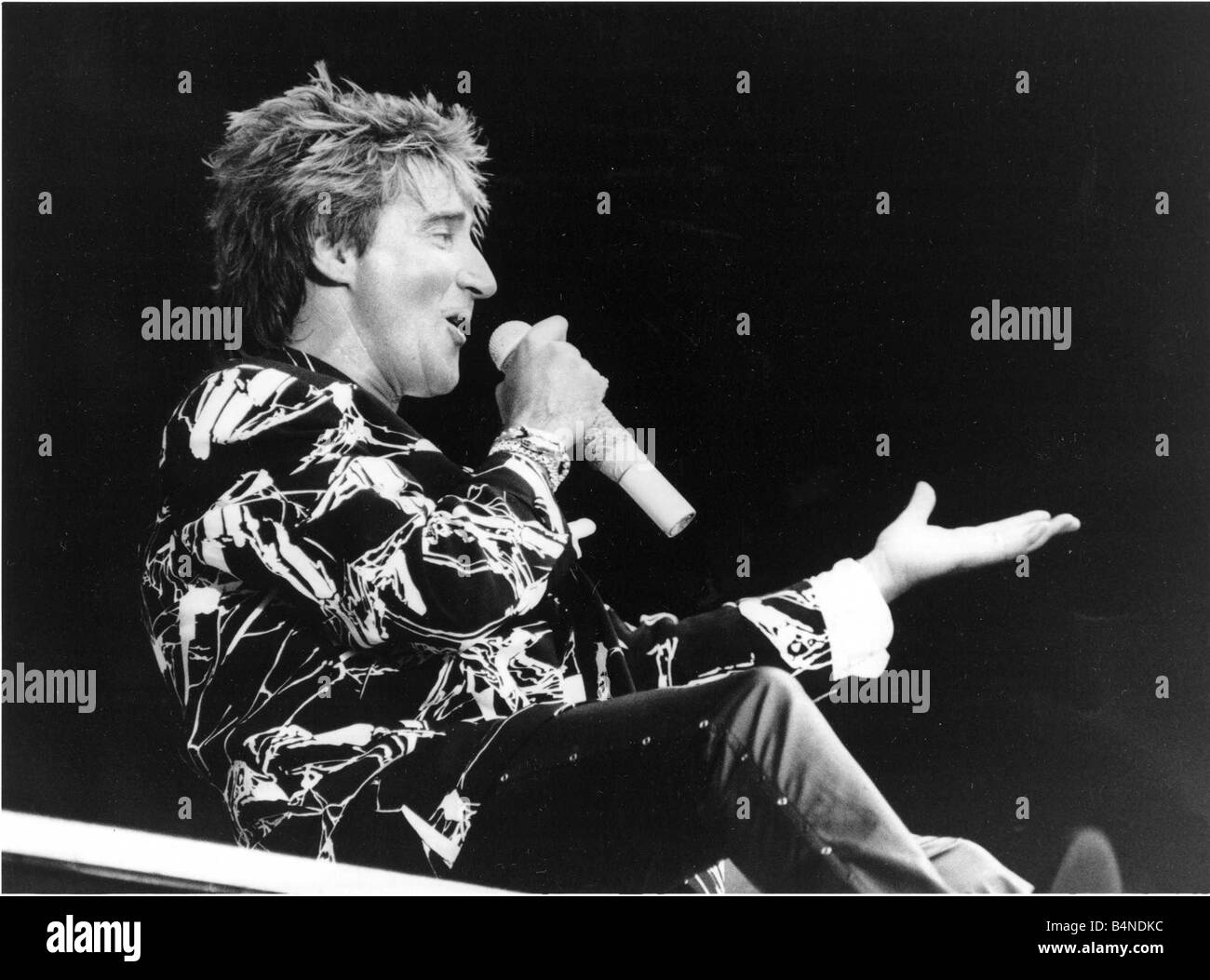Veteran Rocker Rod Stewart went down a storn at Wembley Stadium on 15 July 1986 and so did the rain Rod sang to a sea of umbrellas during an emotional reunion with his old backing band The Faces The band watched by 60 000 fans played together for the first time in 13 years The concert was staged to raise money for a new clinic for victims of multiple sclerosis the disease that struck down former Faces guitarist Ronnie Lane Local Caption retromusic Stock Photo