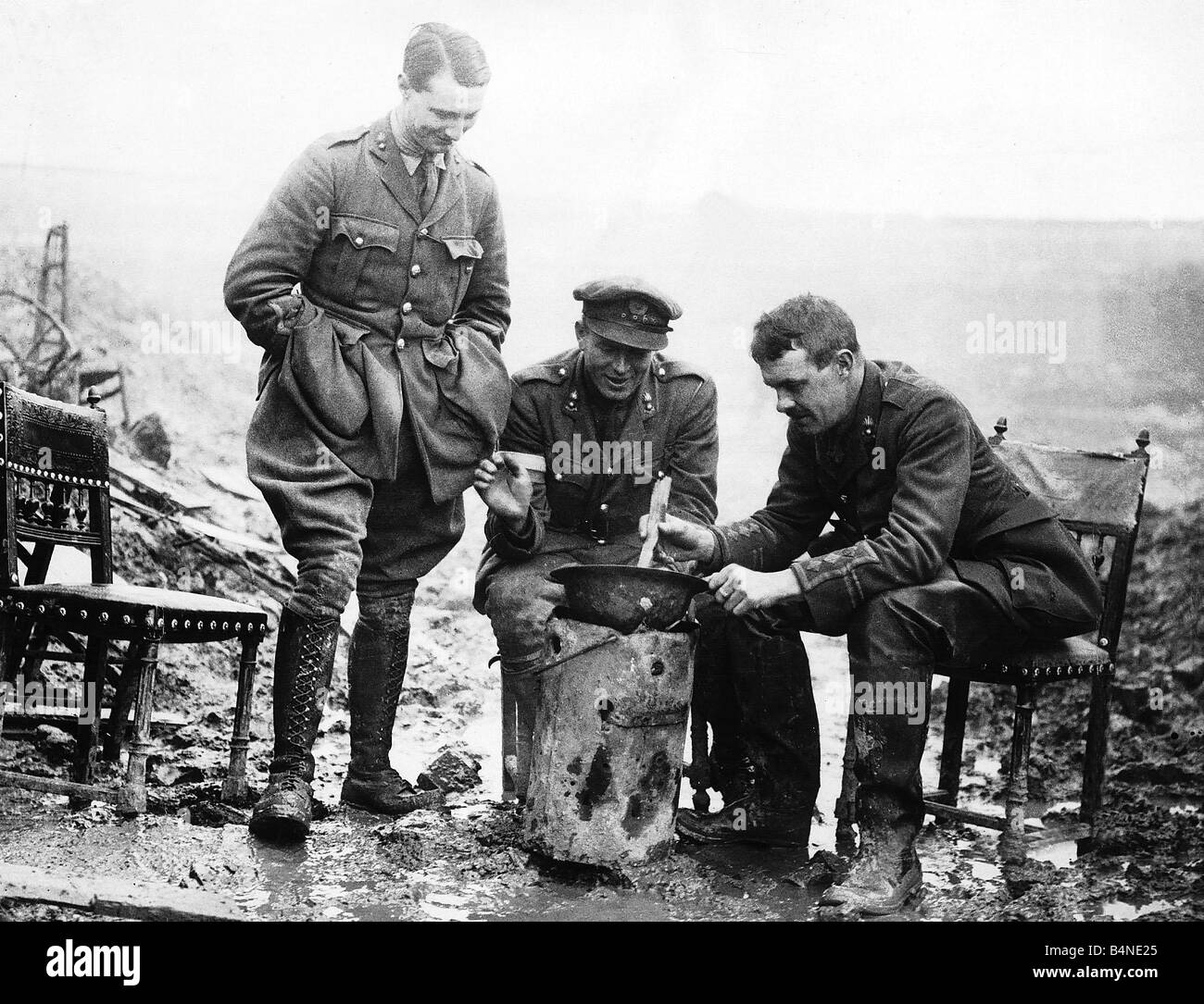 British officers cook a casserole in an army helmet 1917 during World War One Stock Photo