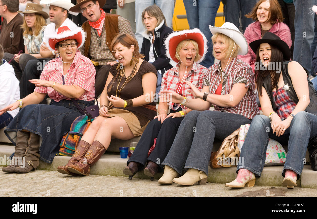 Female girls in crowd singing and clap along to the music at the Creetown Country Music Festival part of Gaelforce Scotland Stock Photo