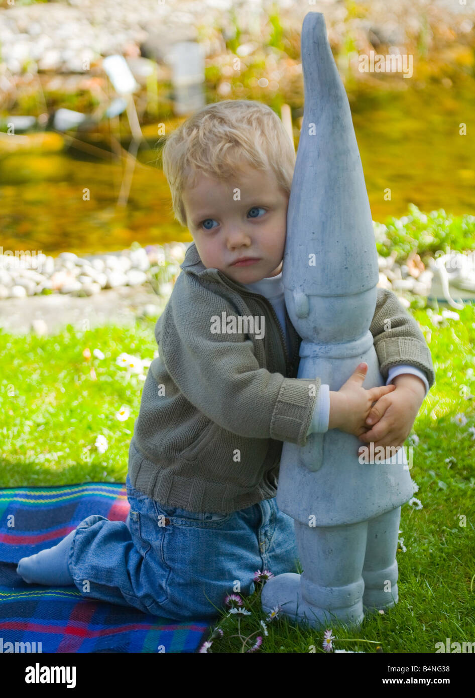 Little boy with modern garden gnome Stock Photo - Alamy