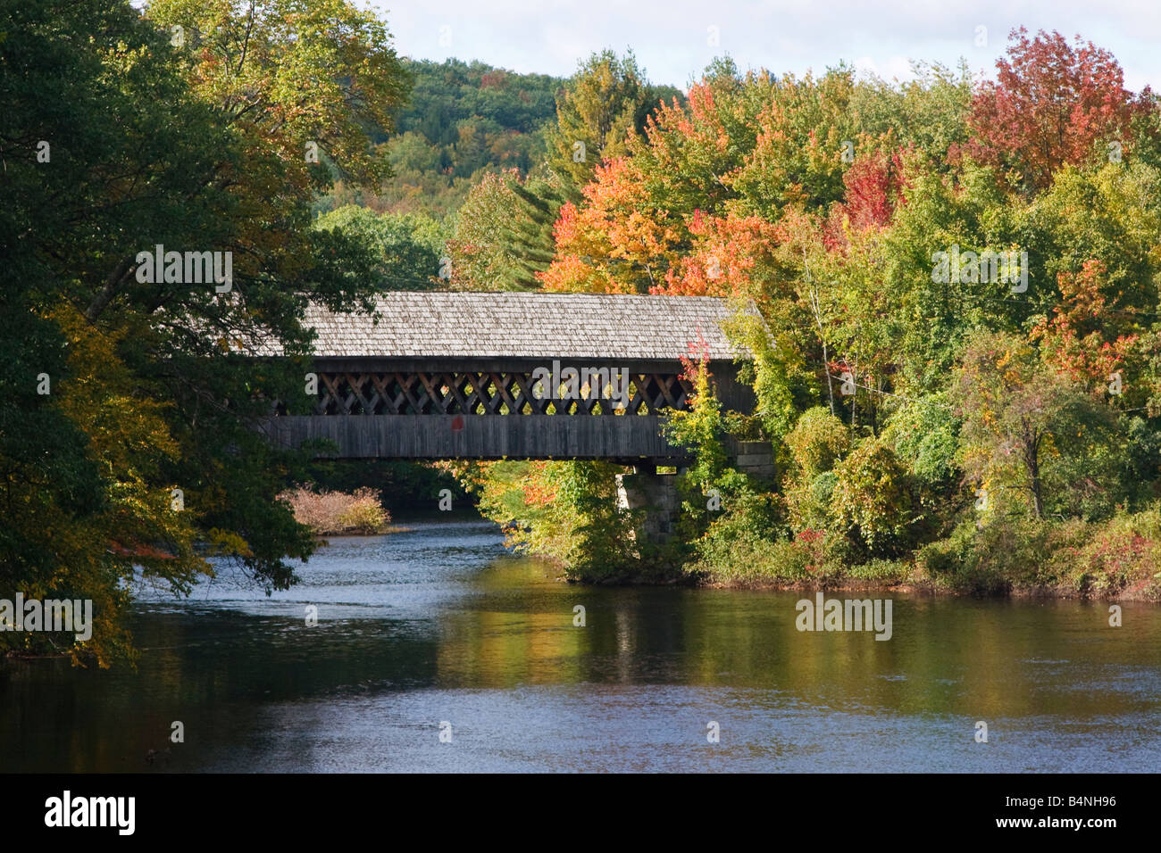 A wooden covered bridge across the Contoocook River in Henniker New