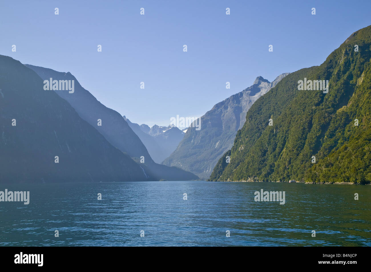 Steep cliffs on each side of Milford Sound, viewed from the sea entrance, South Island, New Zealand Stock Photo