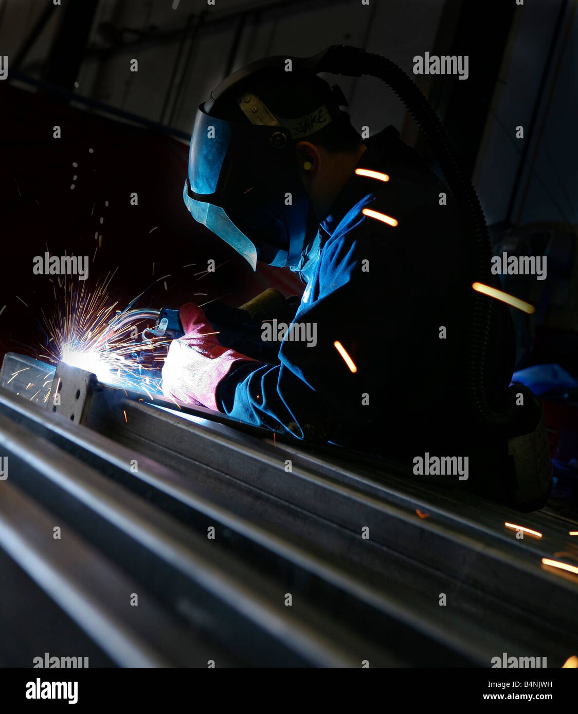 Arc welding on metal in industrial setting Stock Photo