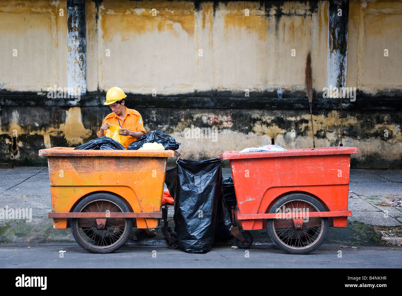 A trash pickup man working to keep the city clean Stock Photo Alamy