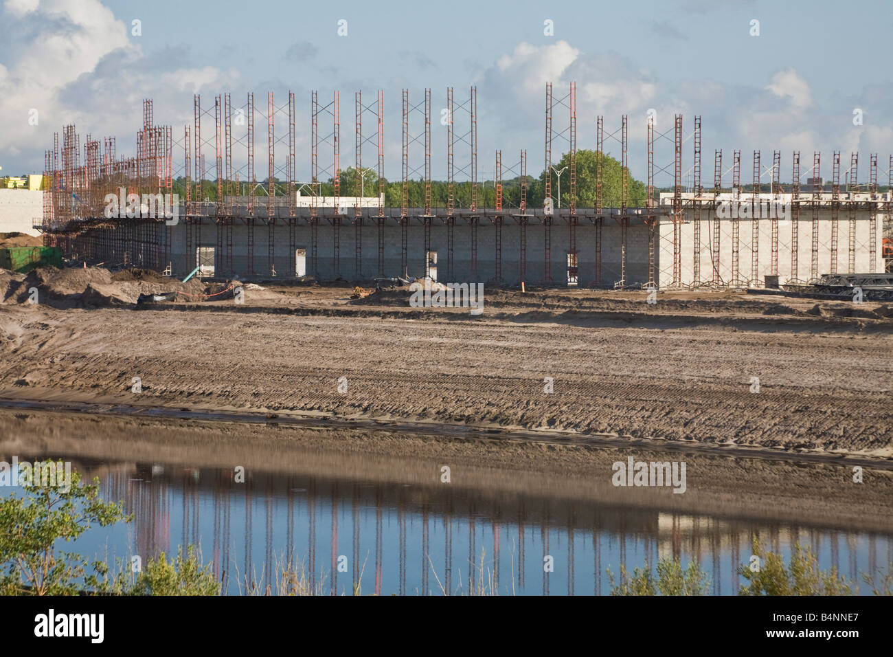 Reflection of construction in a retention pond Stock Photo