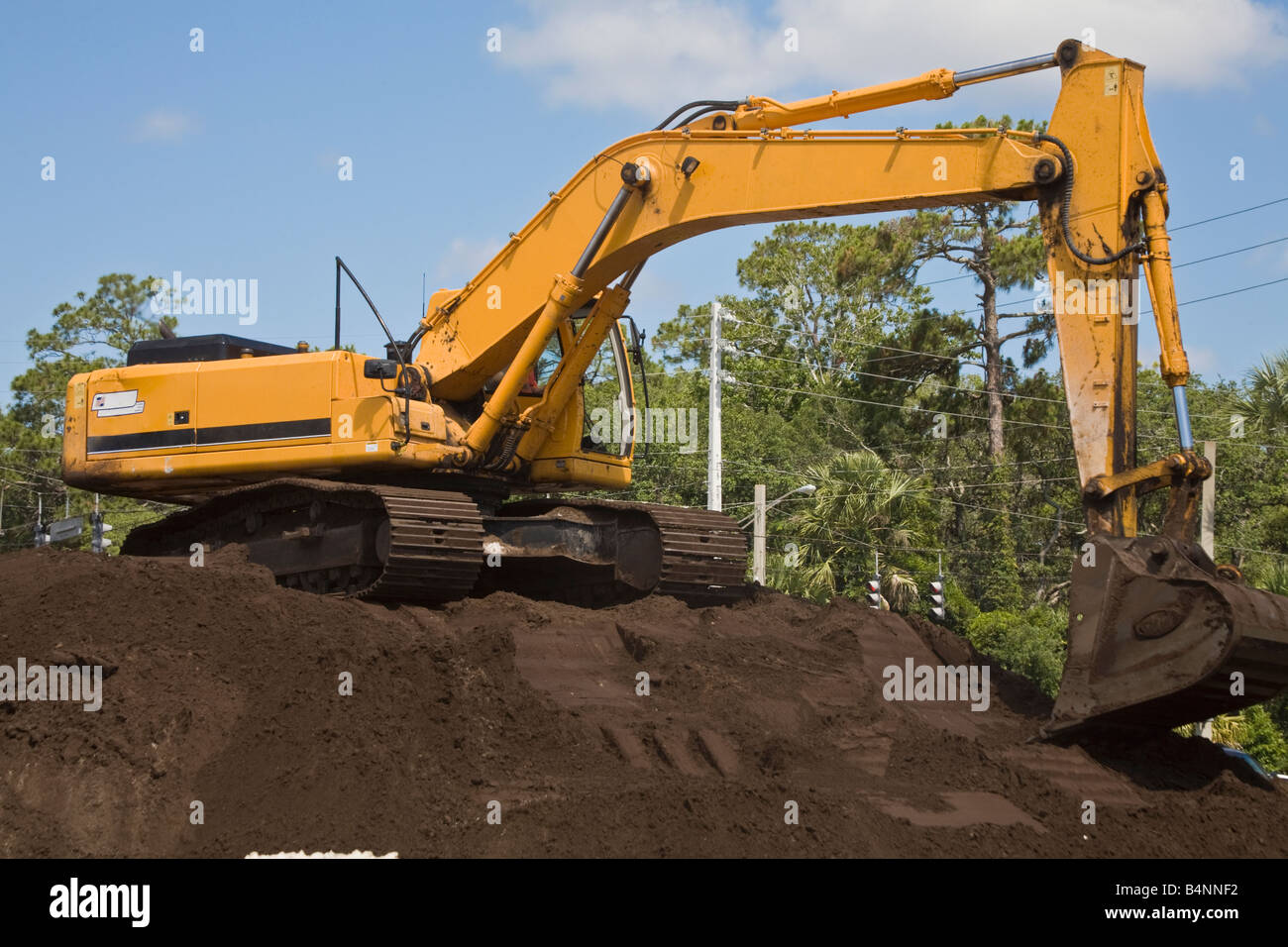 Excavation machinery sitting on a pile of dirt Stock Photo