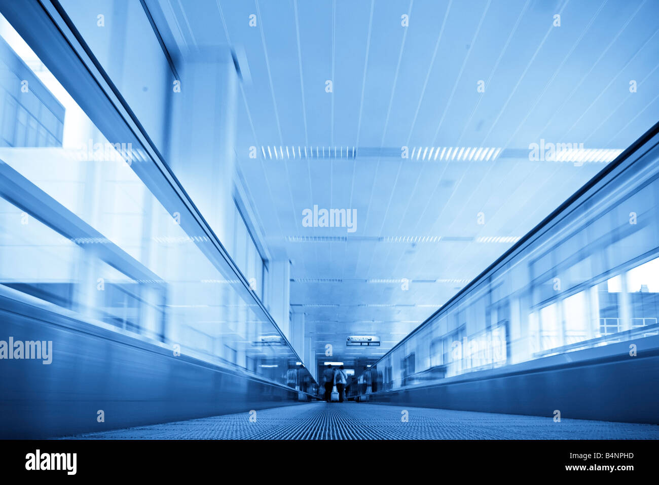 Moving in walkway along blue corridor Stock Photo