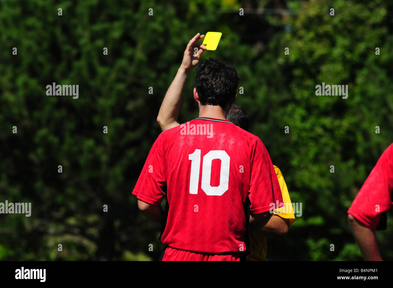 Football or soccer yellow card from the referee due to a penalty Stock Photo