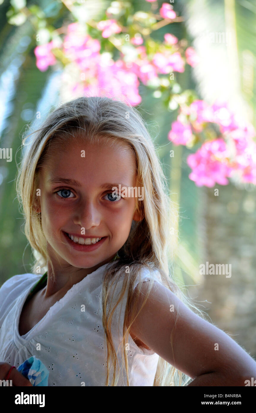 Royalty free photograph of young girl with fair light skin on summer holiday with pretty smile and blonde hair looking happy Stock Photo
