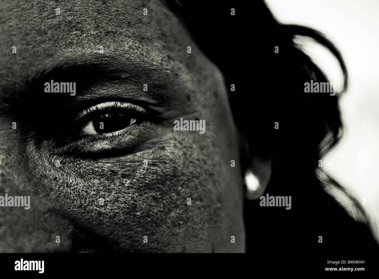 Black eye in black face staring at you Stock Photo