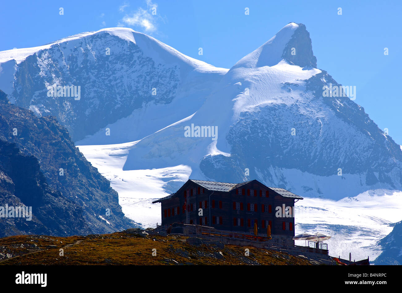 Mountain restaurant Fluhalp against Mt Adlerhorn behind, Zermatt, Valais, Switzerland Stock Photo