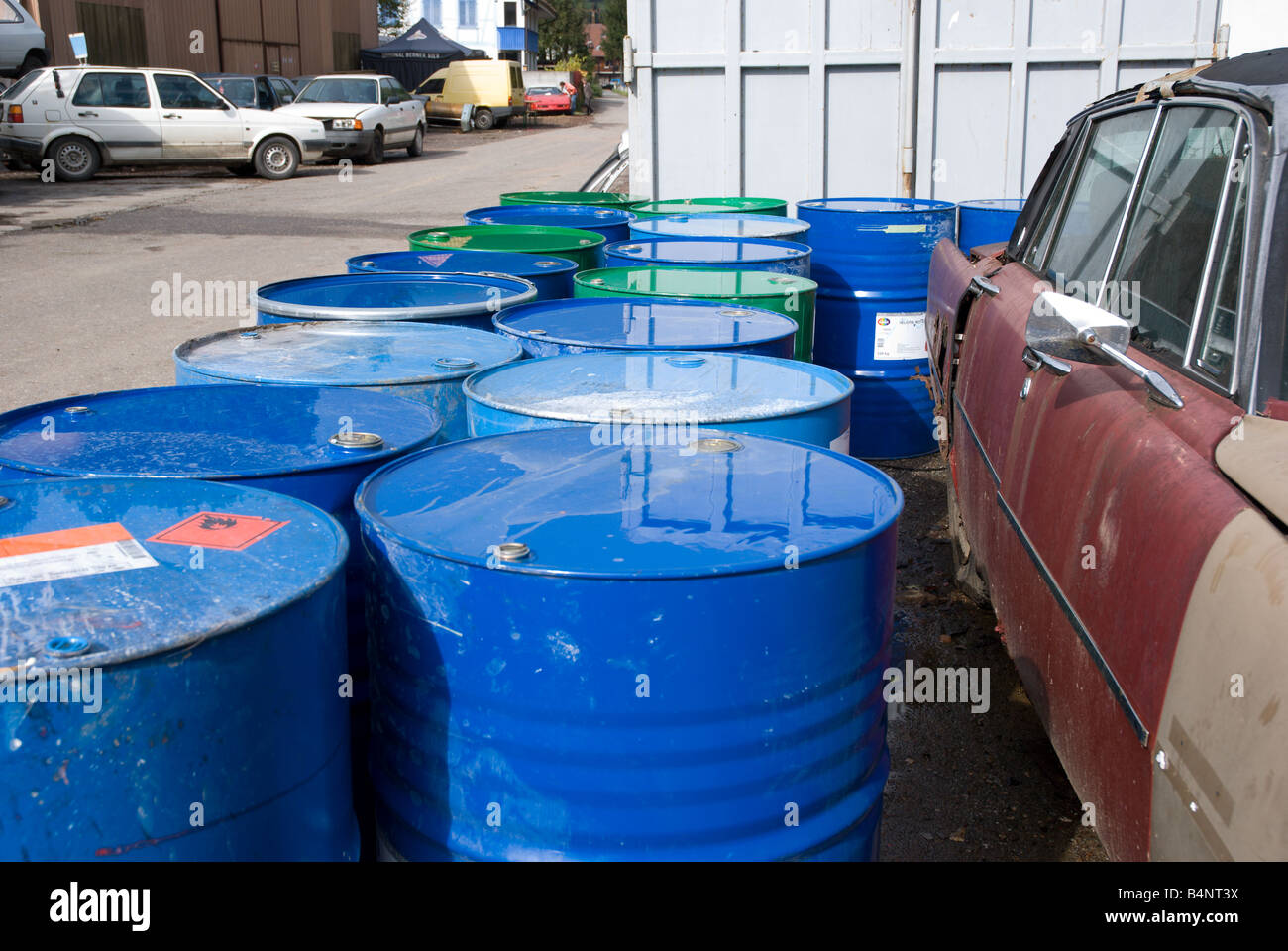 Junkyard barrels of chemical waste sit along side the road at a Swiss