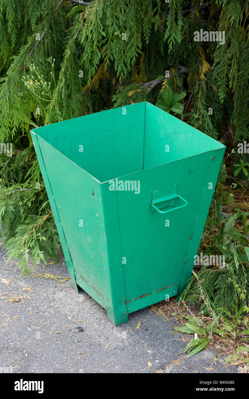 old green recycle bin in a park Stock Photo