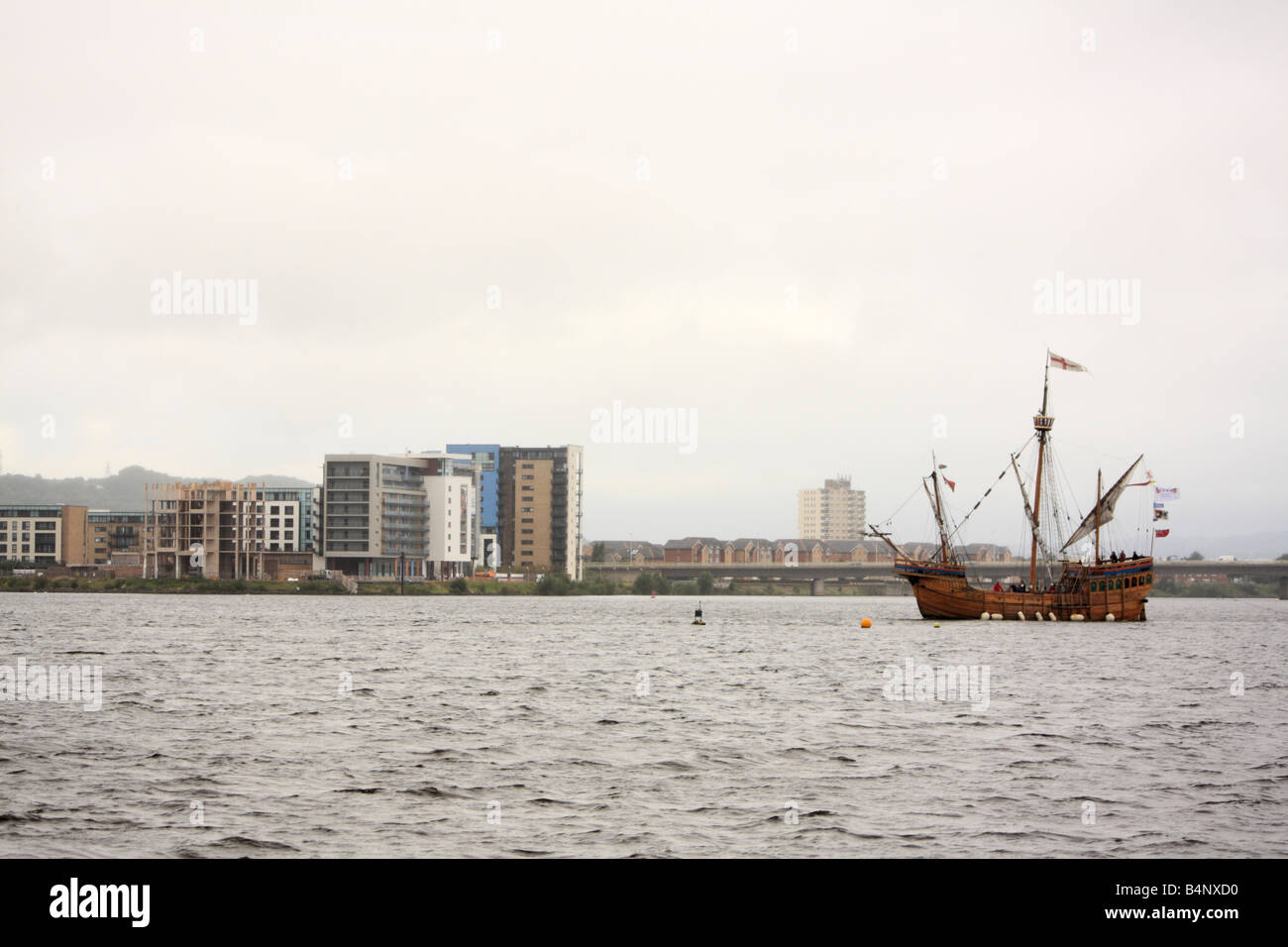 Modern Flats Viewed From The Cardiff Bay Barrage, Wales, U.K. with an old-fashioned ship sailing past Stock Photo