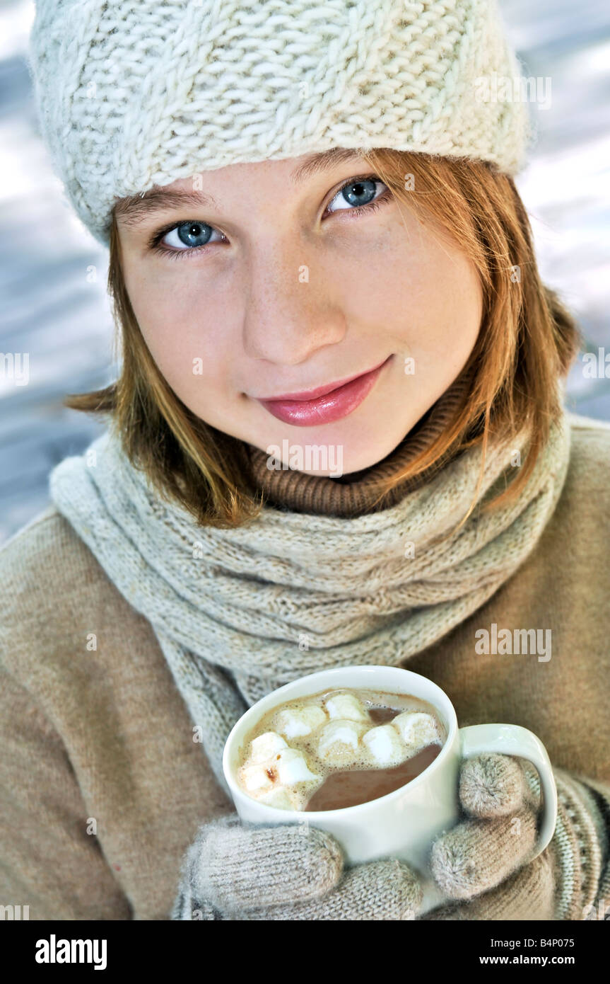 Teenage girl in winter hat with cup of hot chocolate Stock Photo