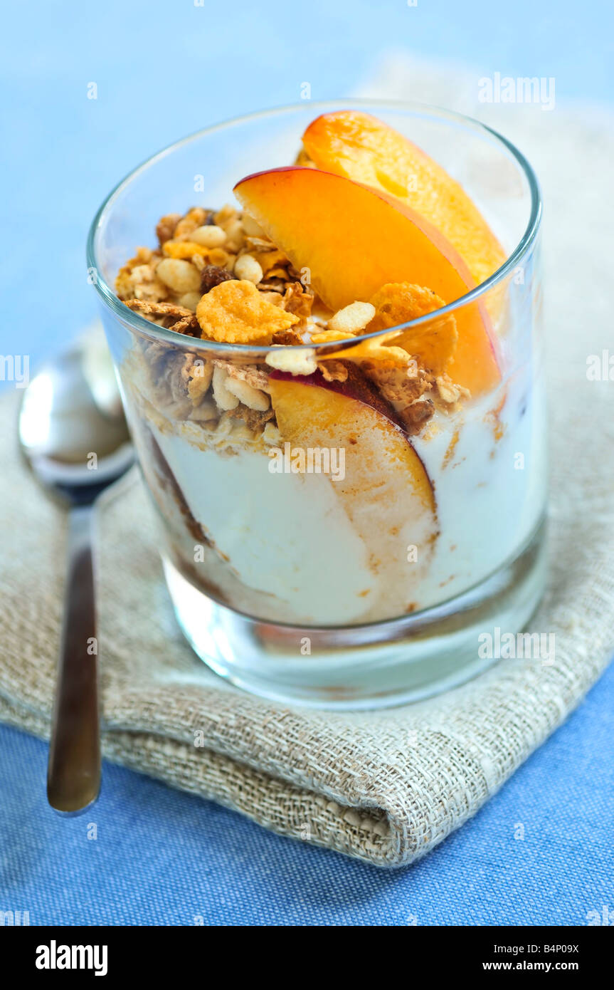 Serving of yogurt with fresh peaches and granola Stock Photo Alamy